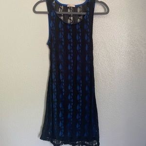 Black lace with blue tunic underneath & open low back